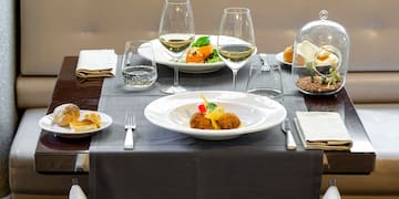 a table with plates of food and glasses on it