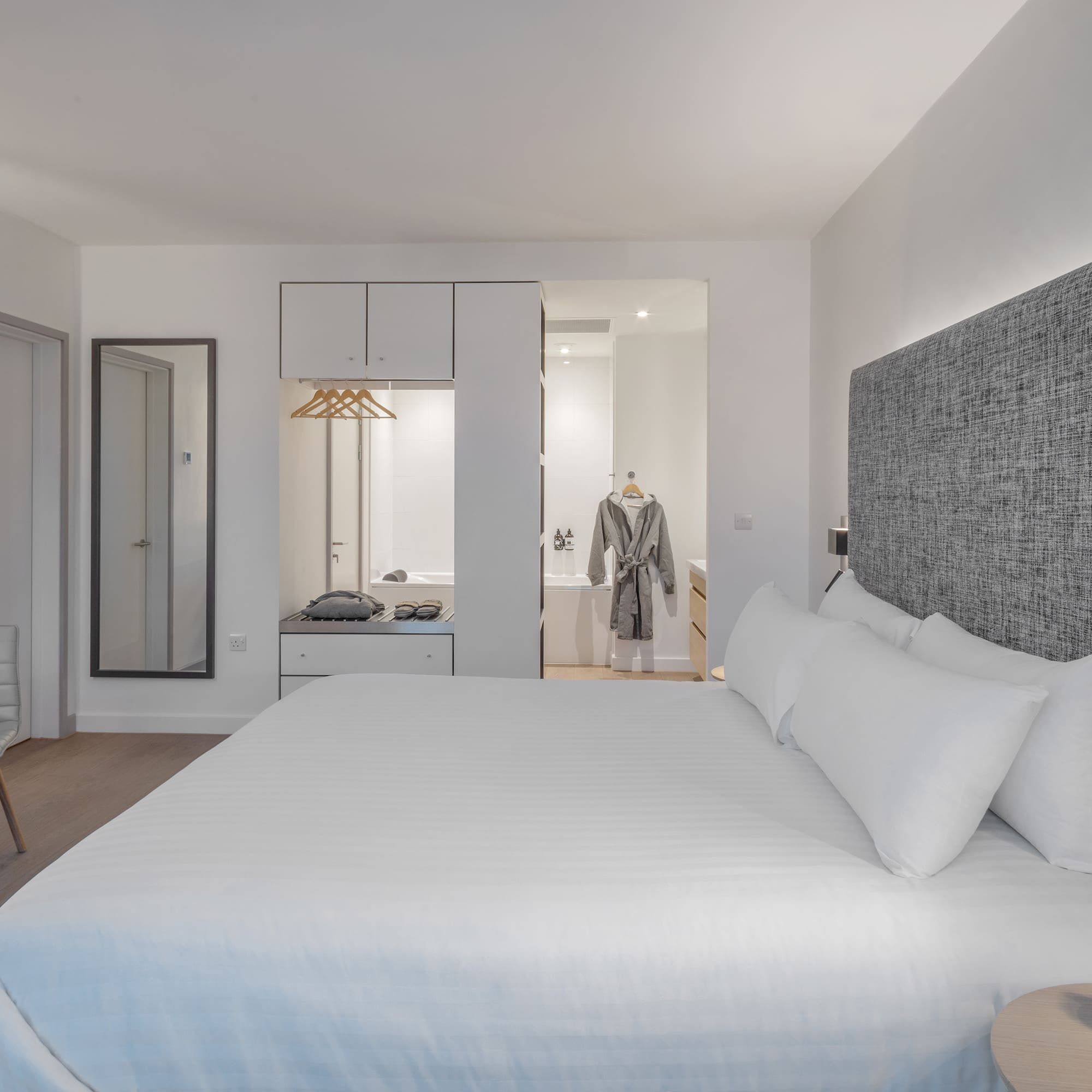 a bedroom with a bed and a mirror