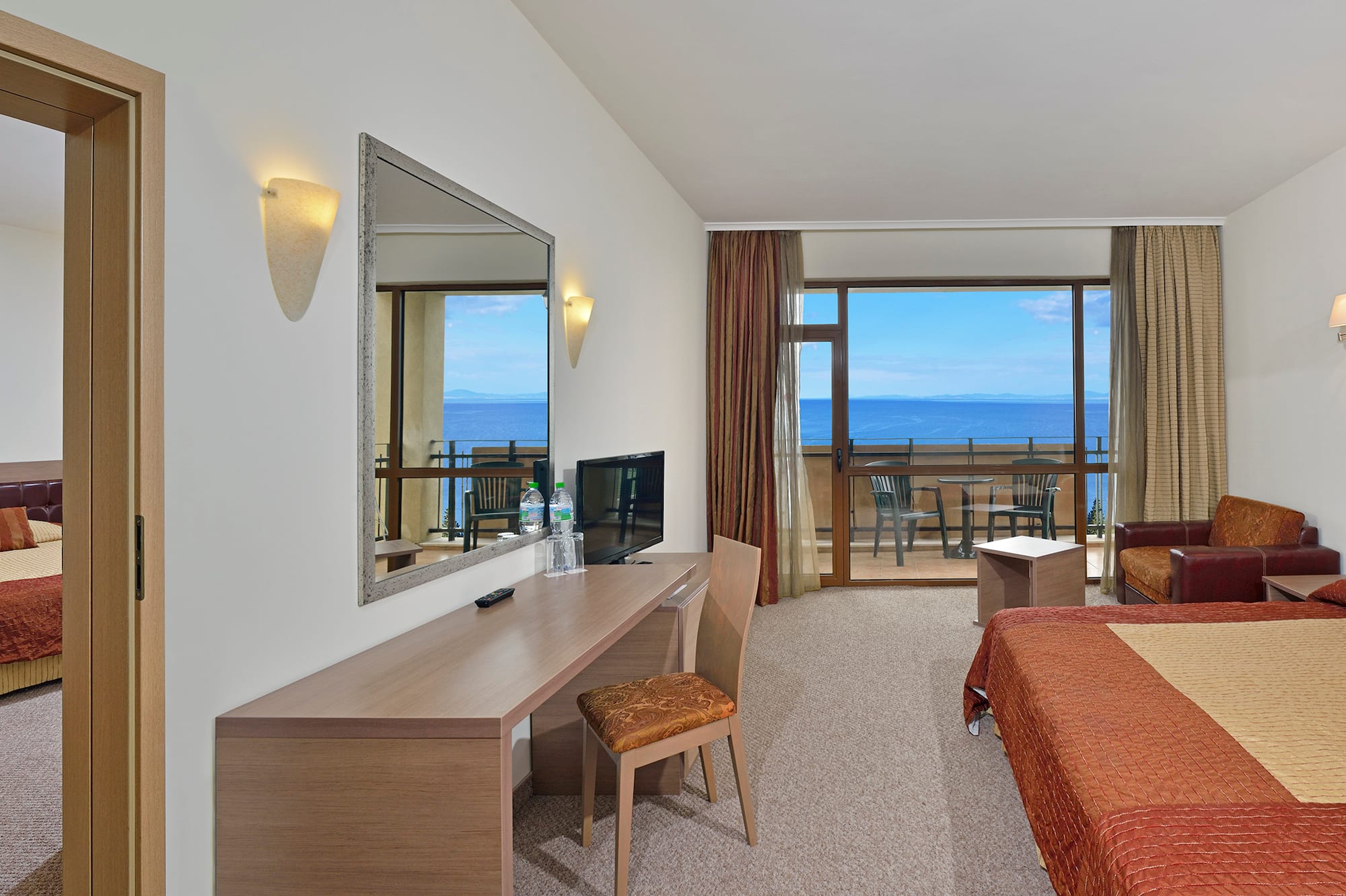 a room with a bed and a mirror