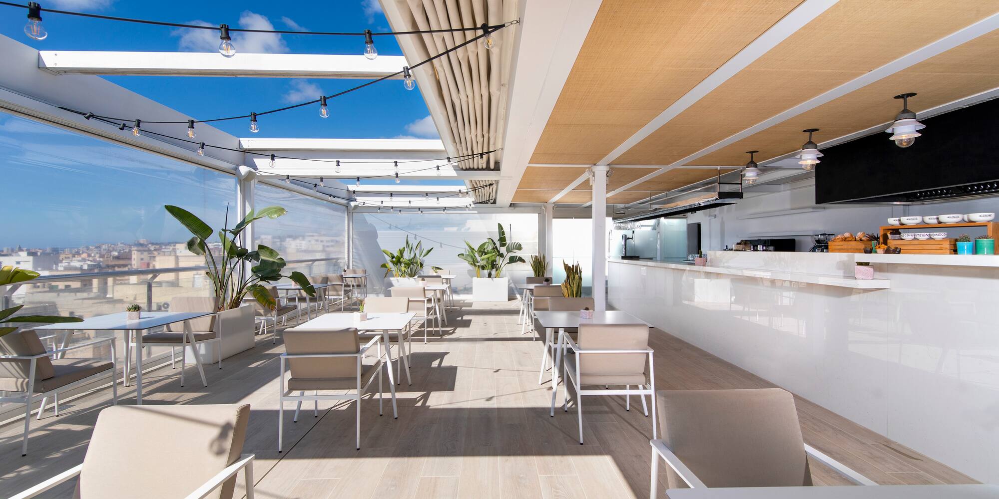 a white restaurant with tables and chairs