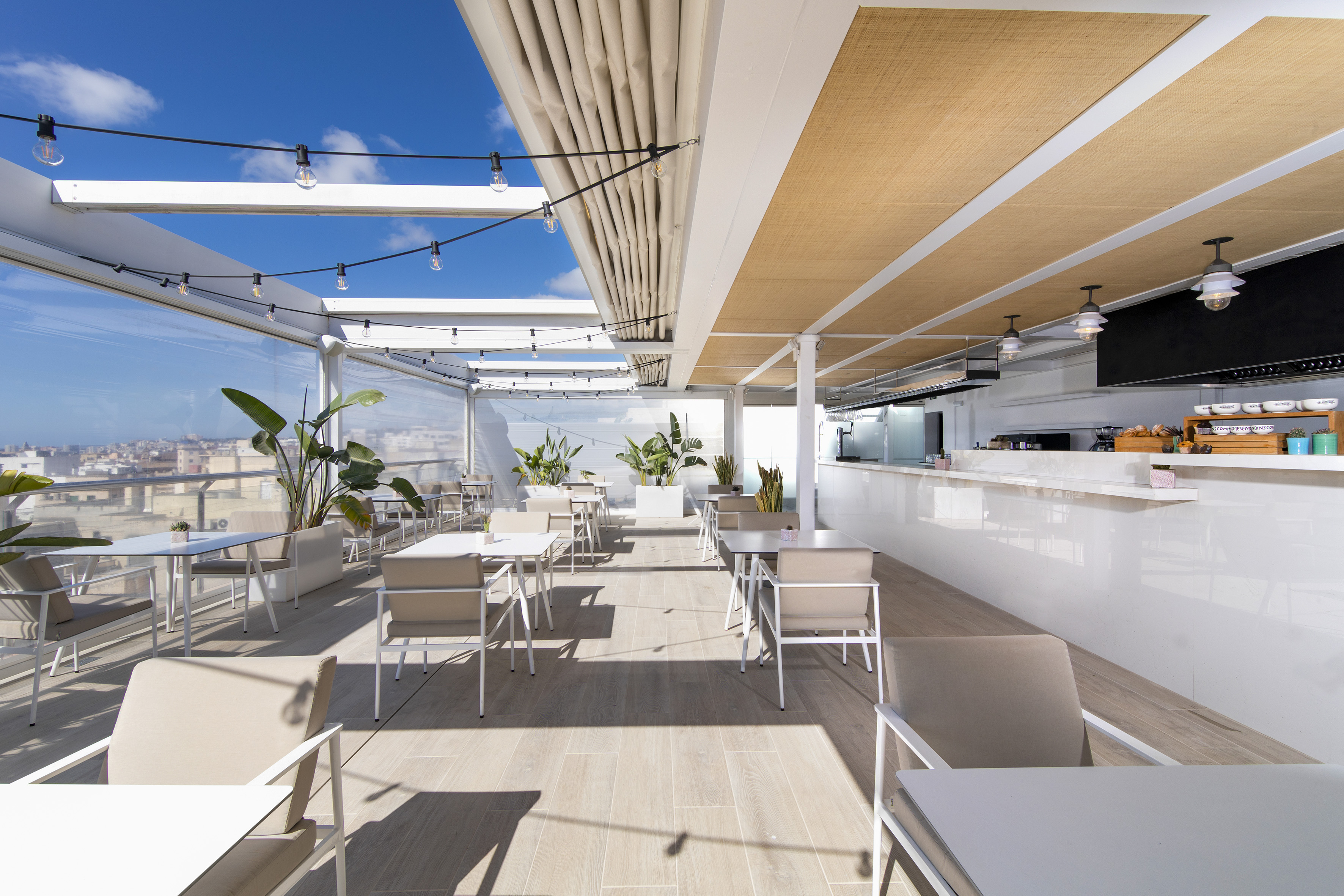 a white restaurant with tables and chairs