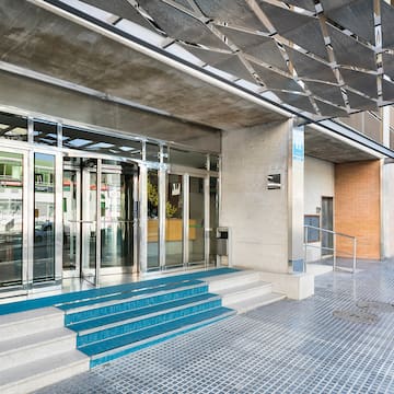 a building with glass doors and stairs