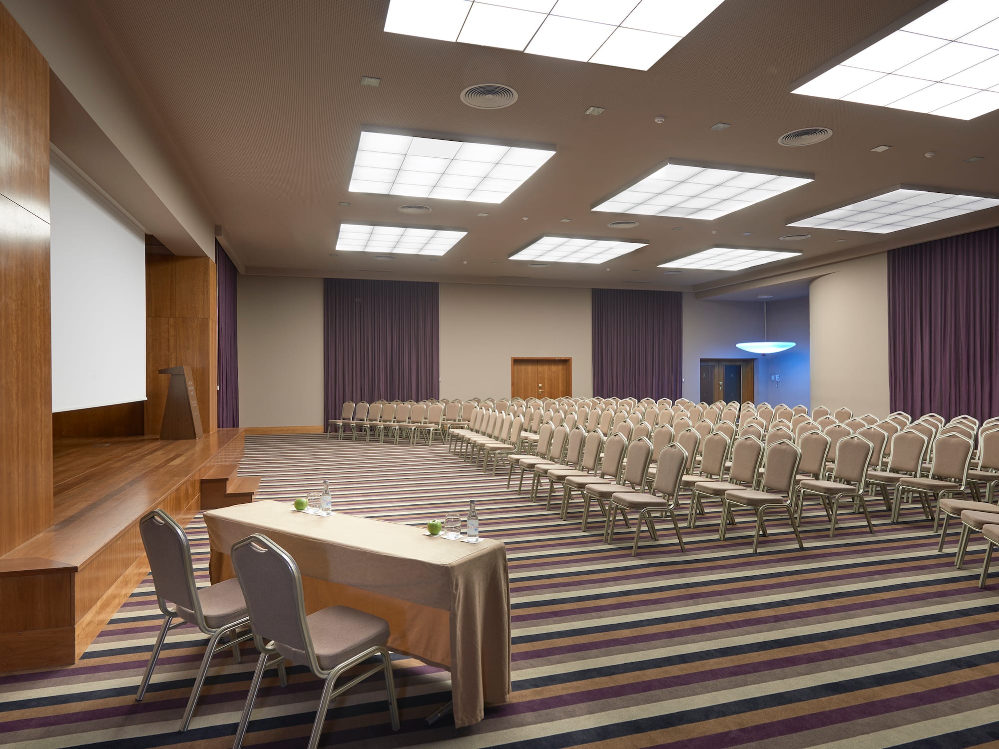 a room with a large screen and chairs