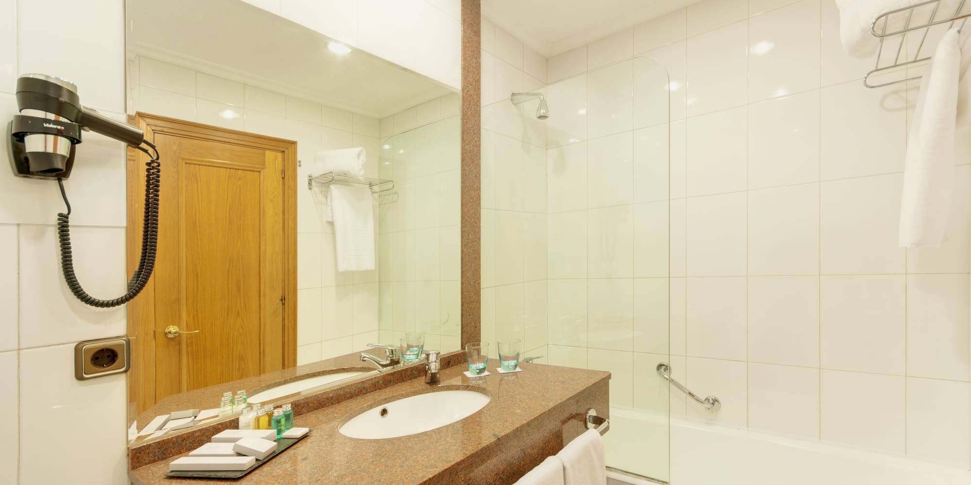 a bathroom with a marble countertop and a shower
