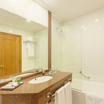 a bathroom with a marble countertop and a shower