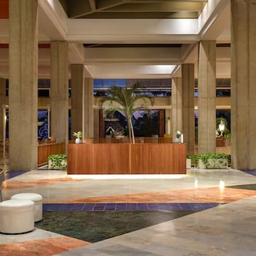 a lobby with a palm tree