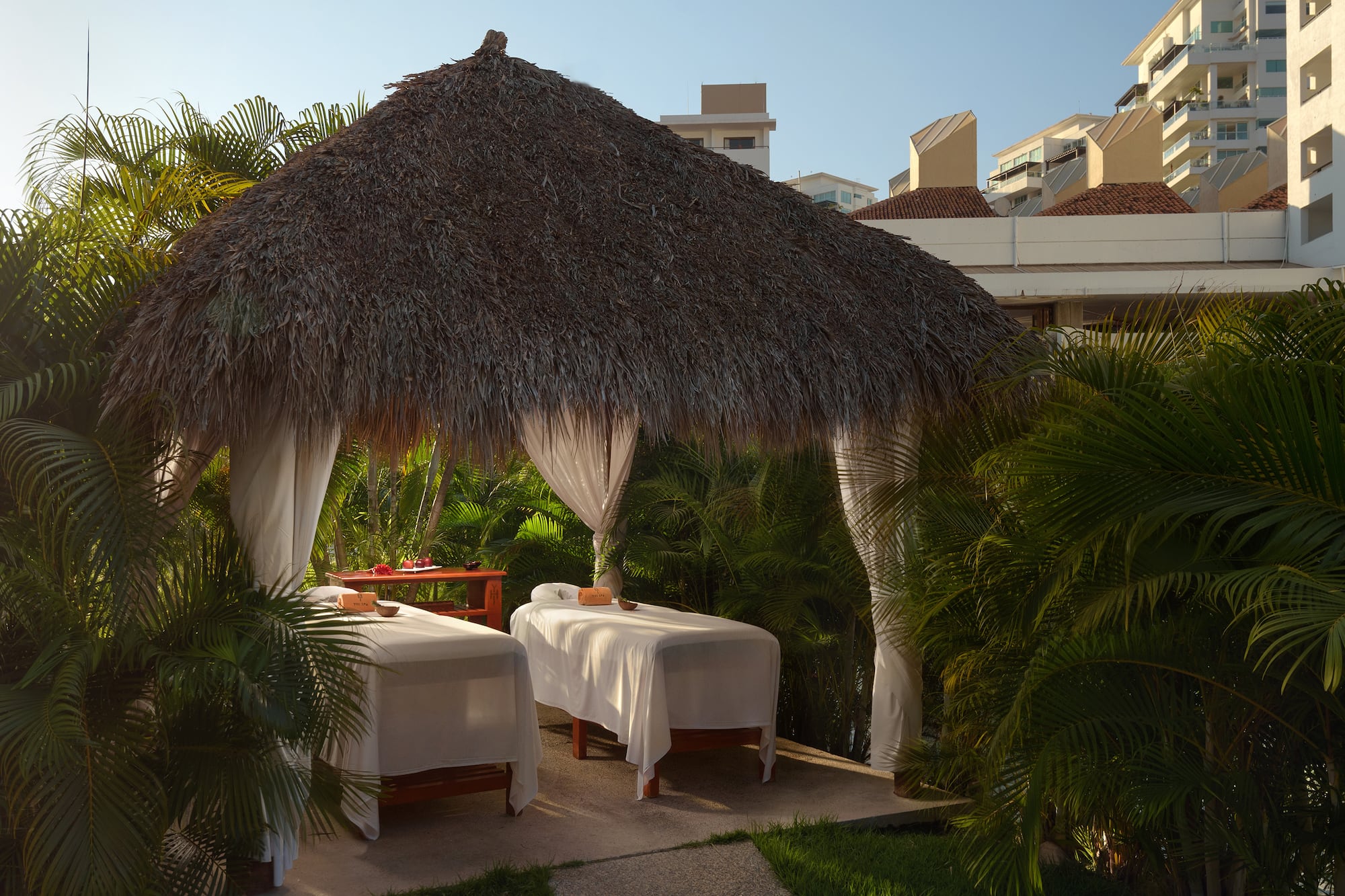 a massage tables under a straw hut