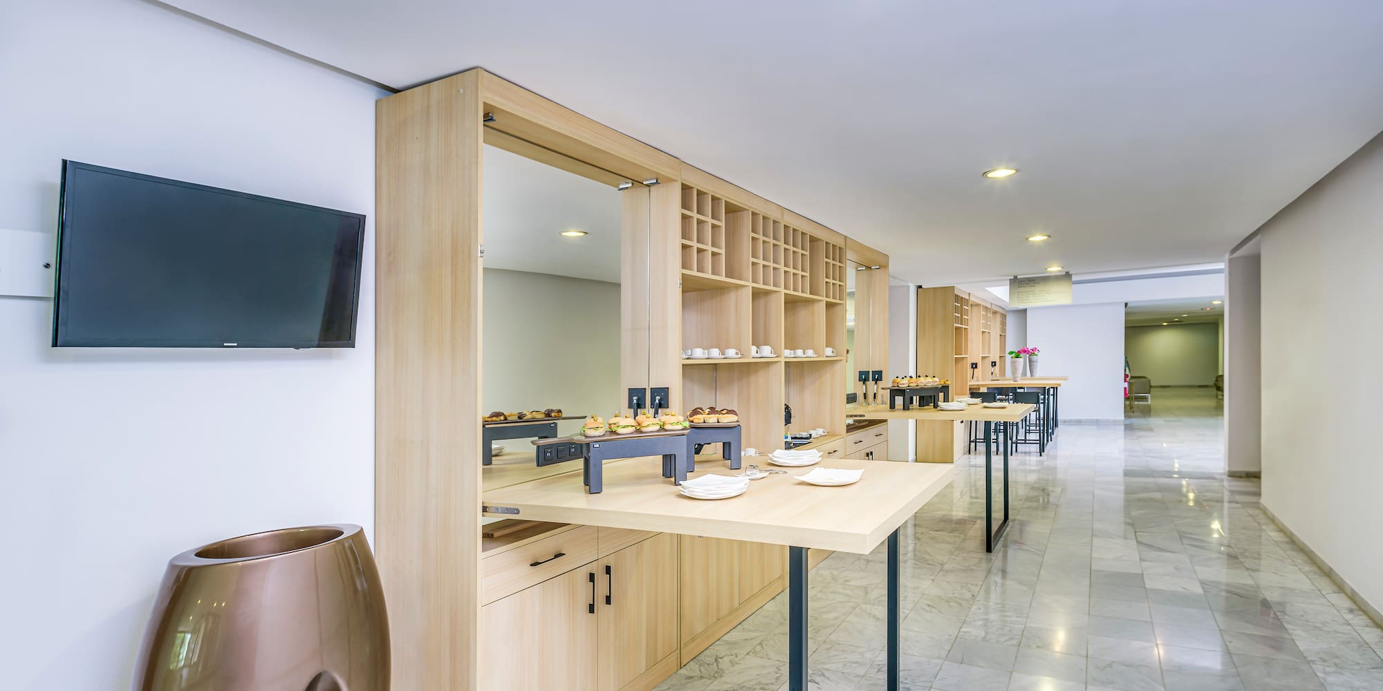 a room with a buffet table and a tv