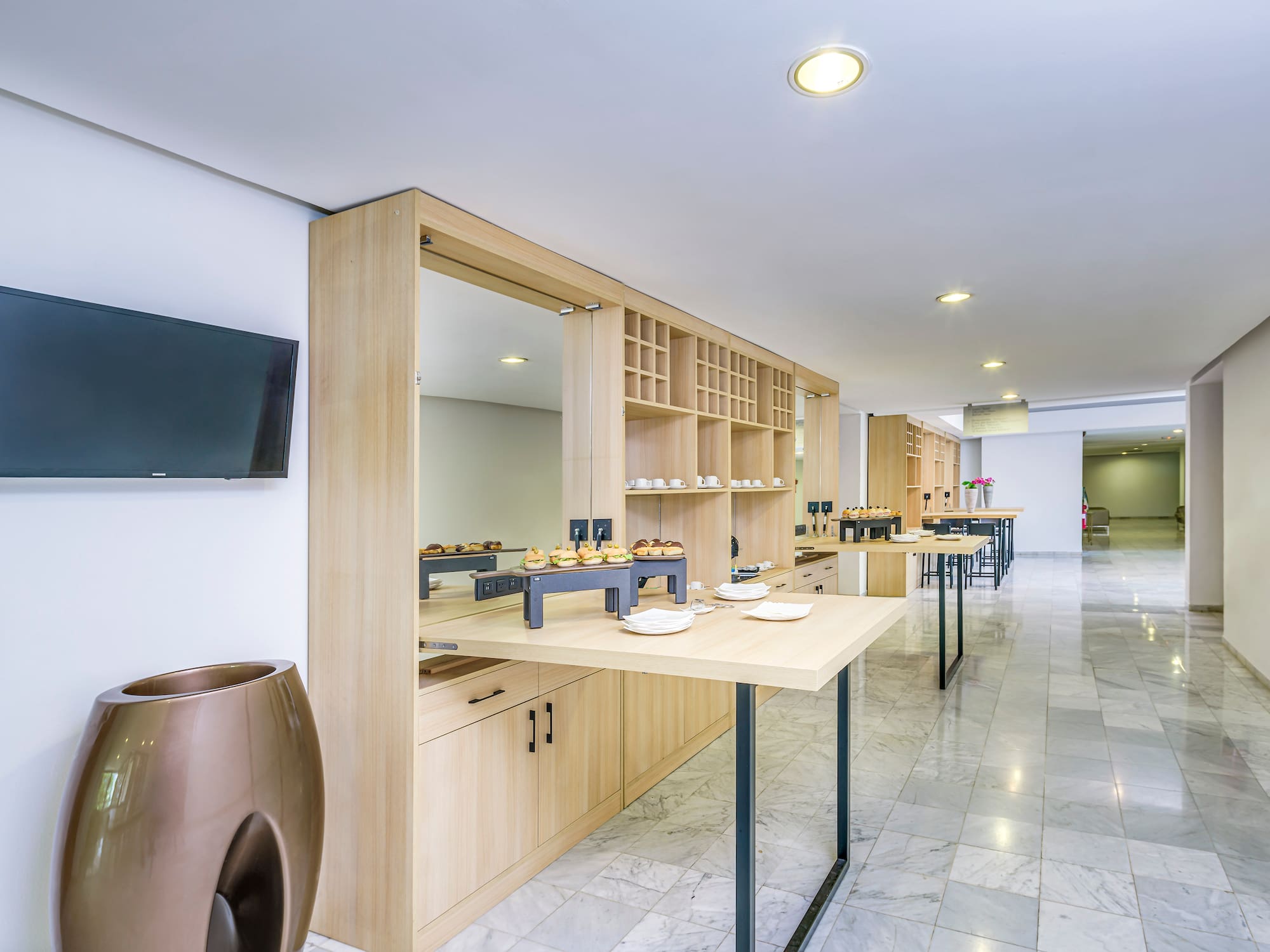 a room with a buffet table and a tv