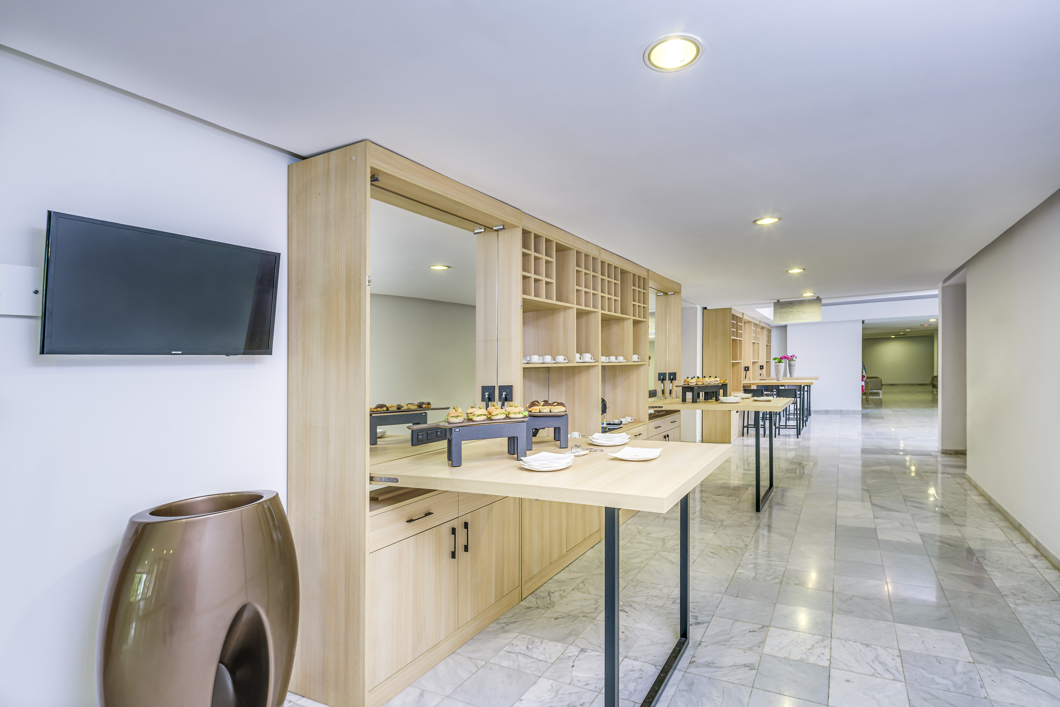 a room with a buffet table and a tv