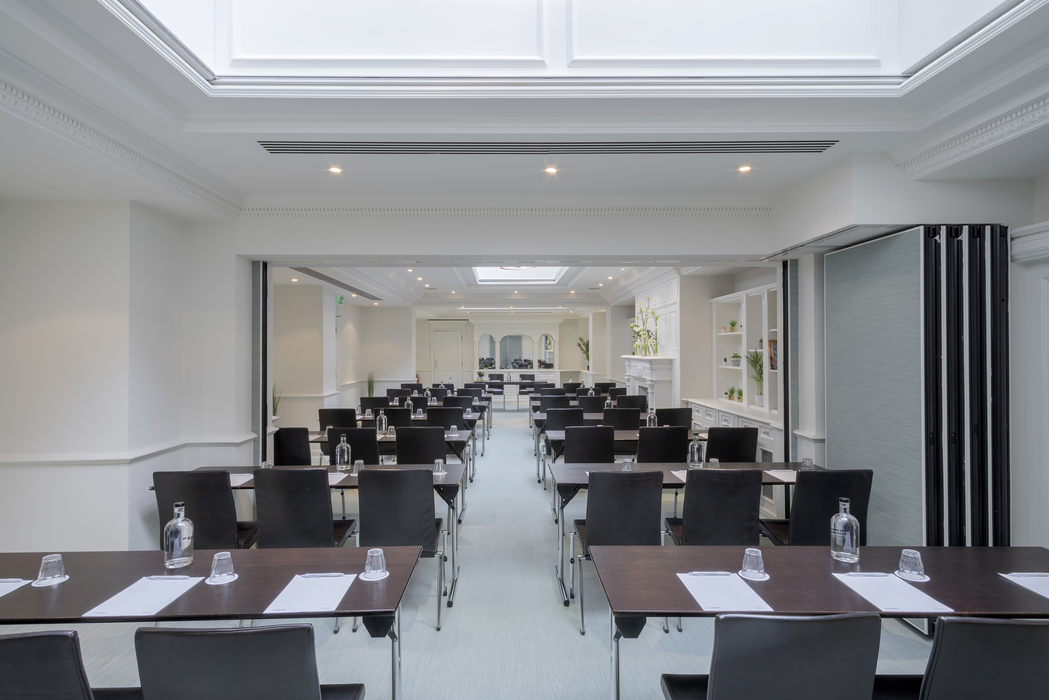 Bright modern conference room with classroom setup. Tables, chairs.