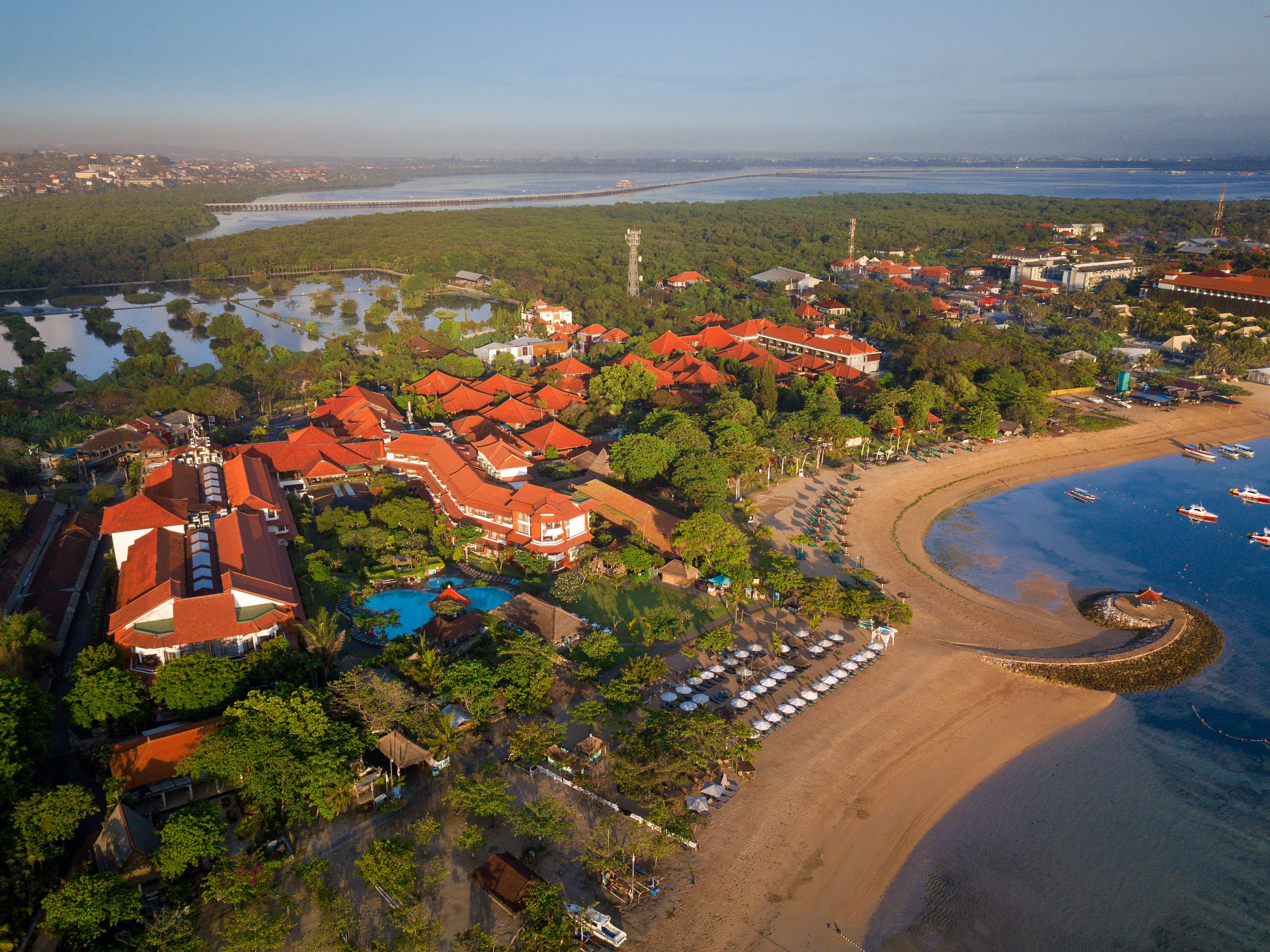 a beach with buildings and trees