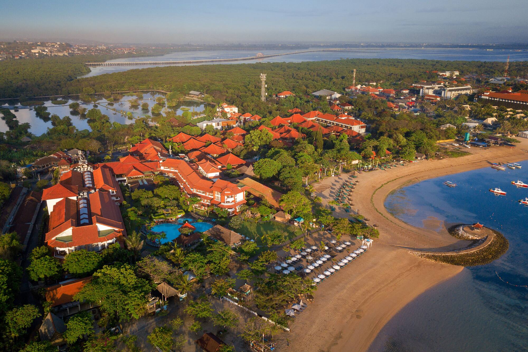 a beach with buildings and trees