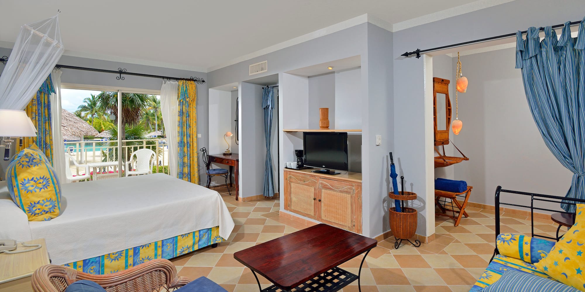 a room with a bed and a television