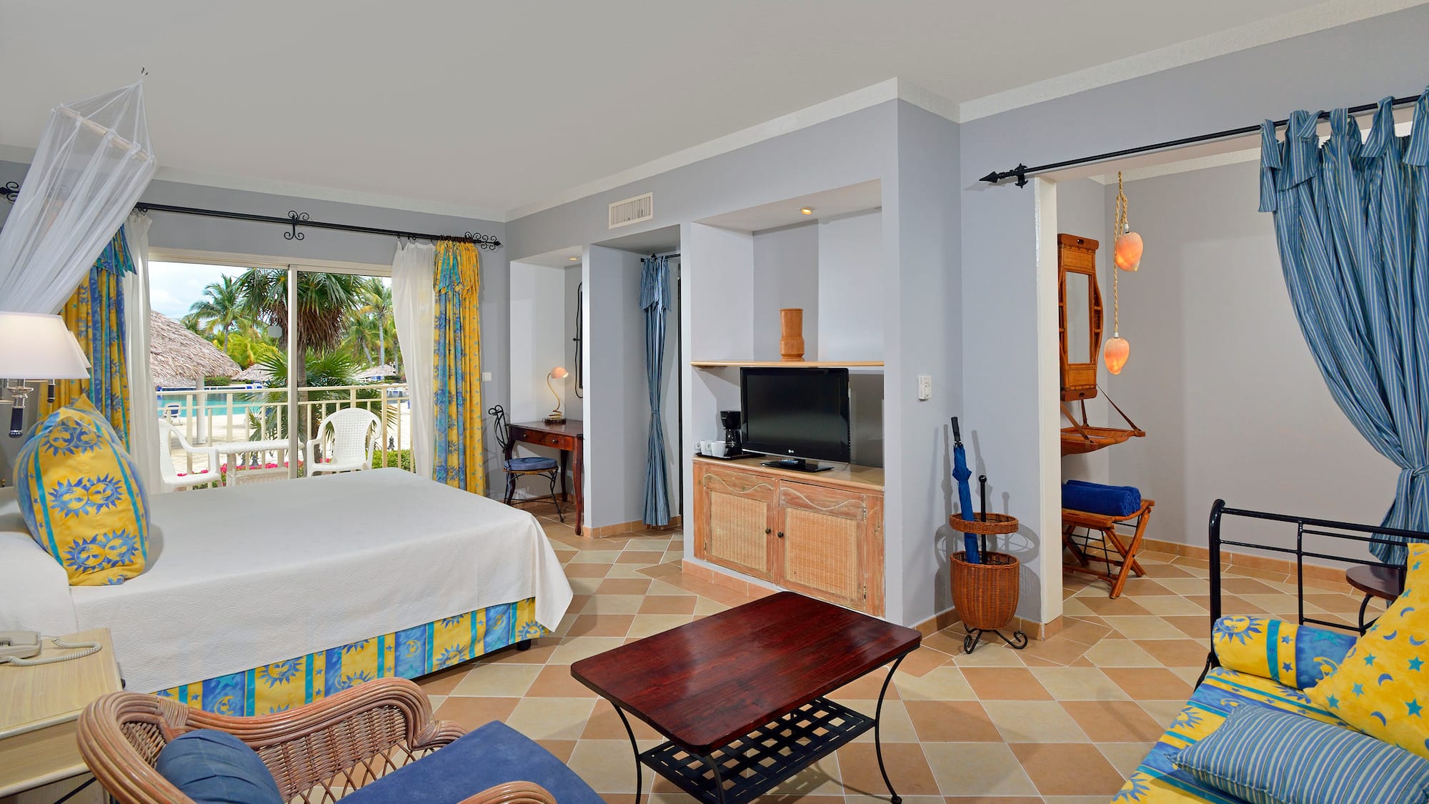 a room with a bed and a television