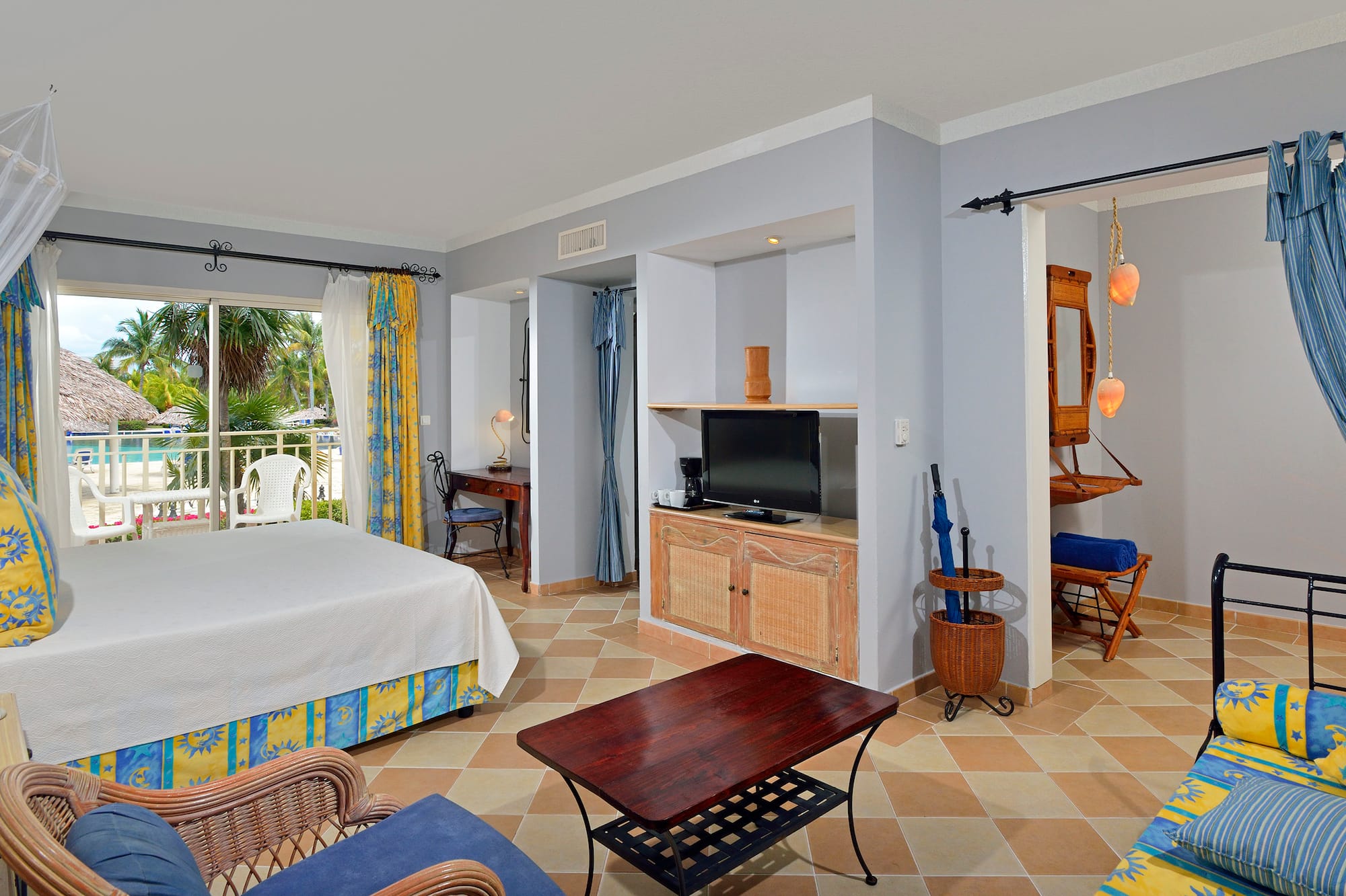 a room with a bed and a television