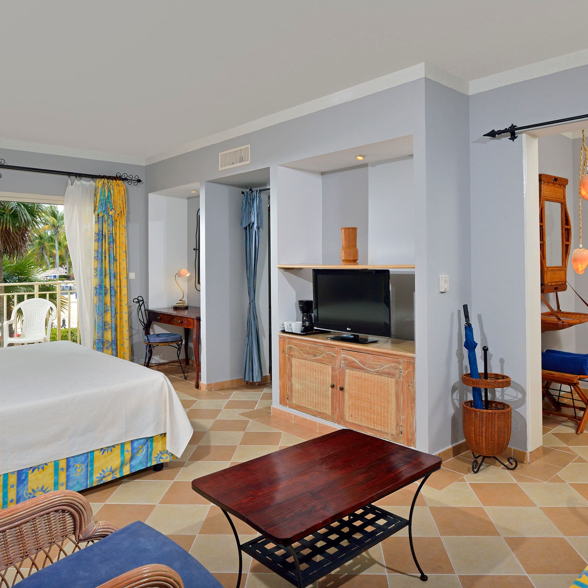 a room with a bed and a television