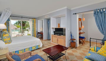 a room with a bed and a television