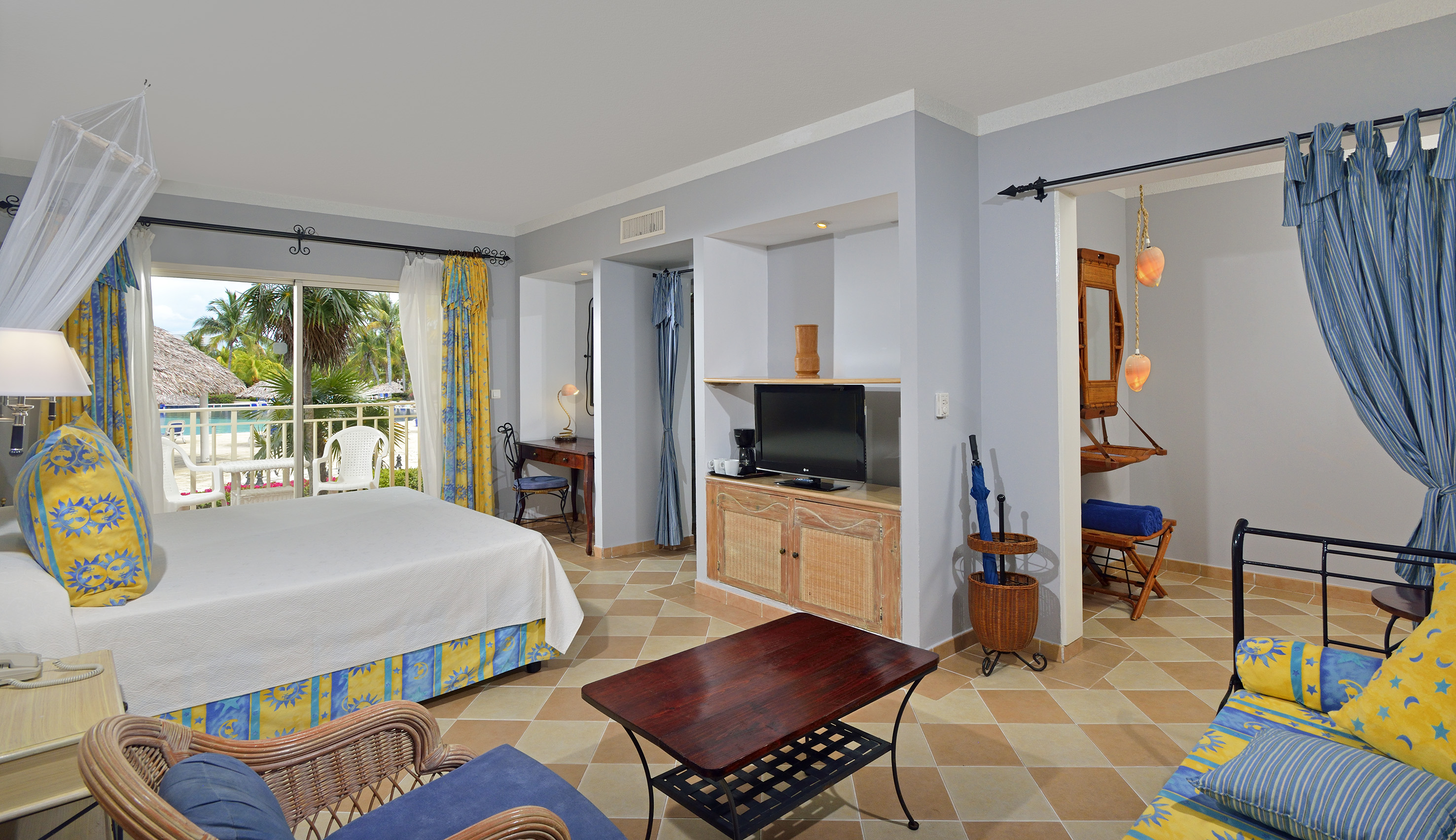 a room with a bed and a television