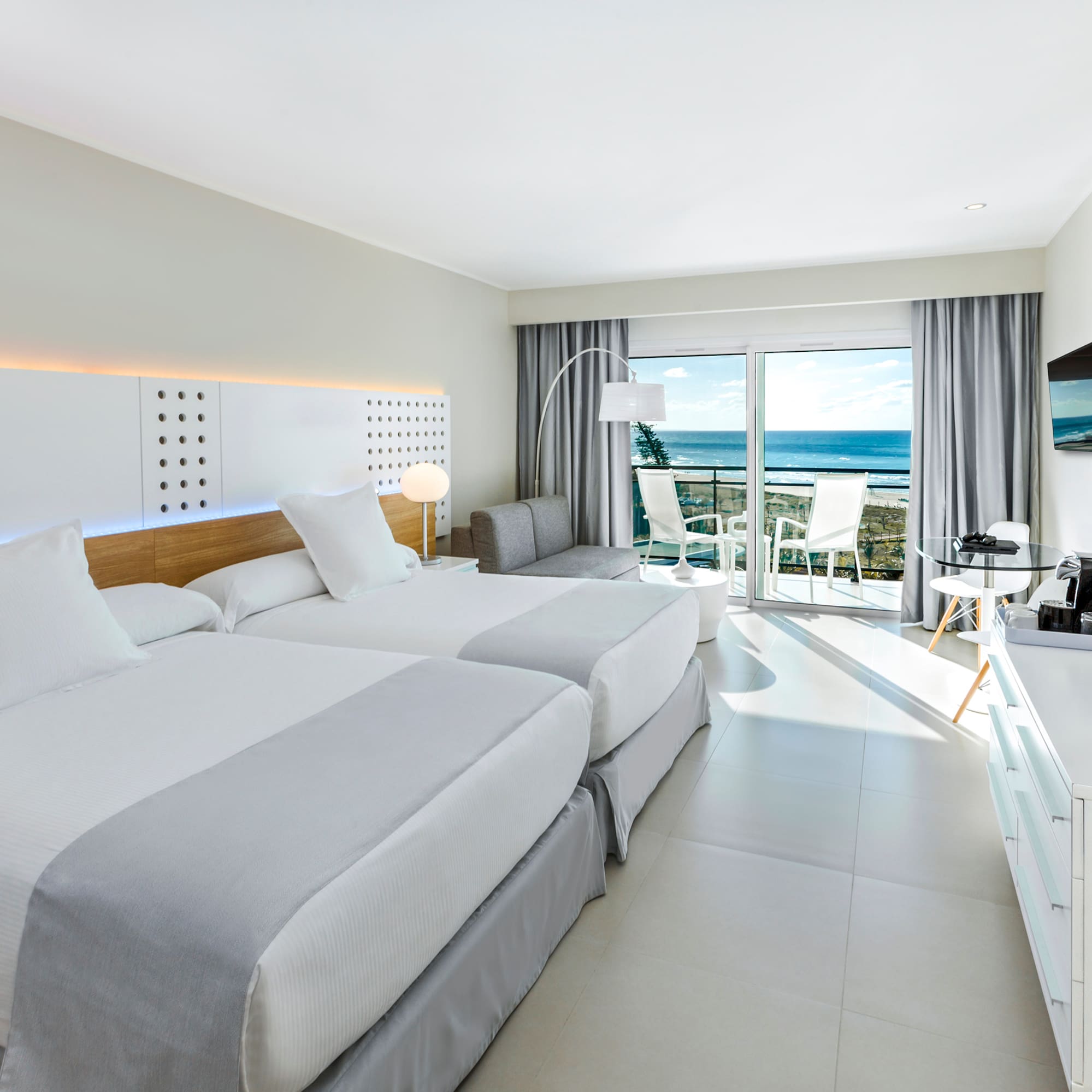 a room with two beds and a television