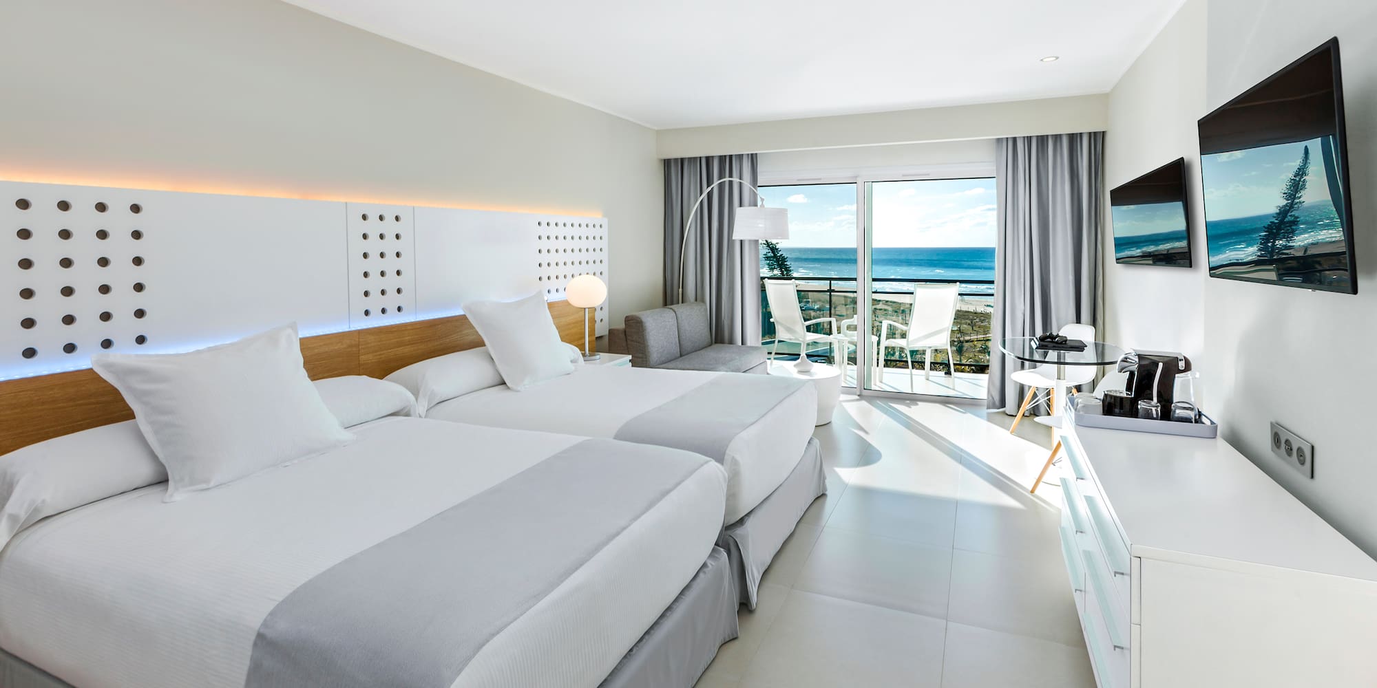 a room with two beds and a television