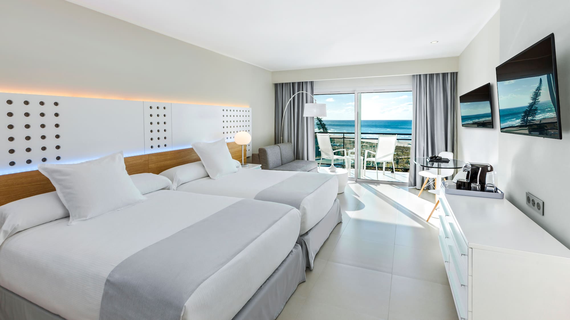 a room with two beds and a television