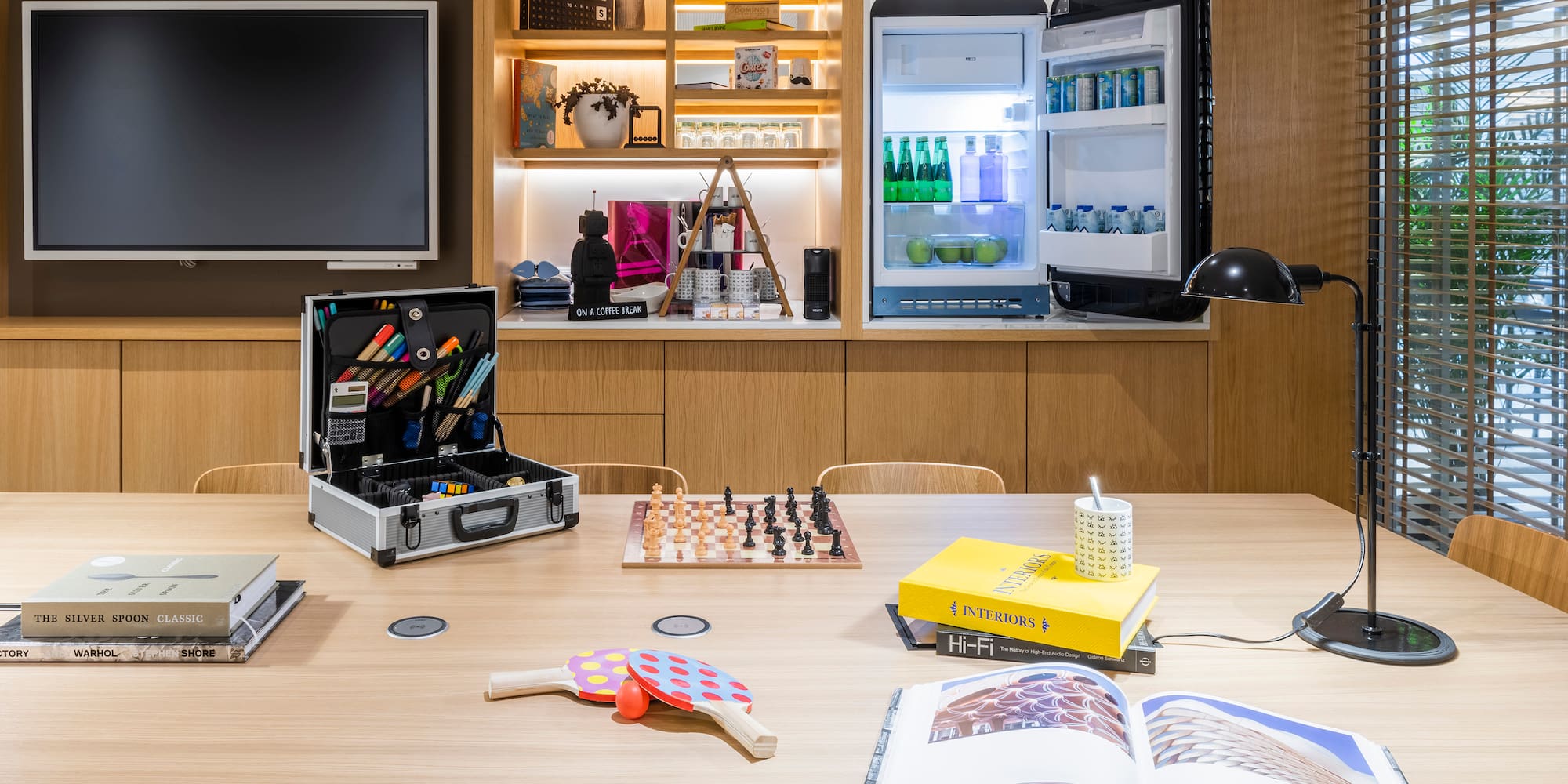 a table with a book and a chess board on it