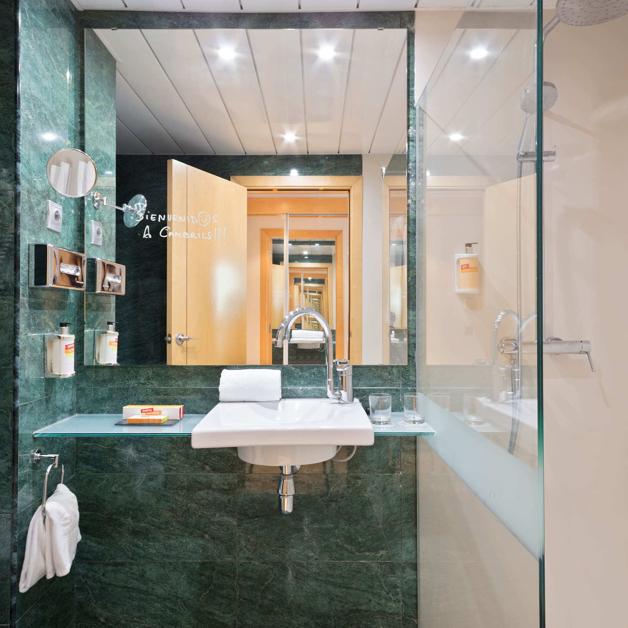 a bathroom with a glass shower and sink