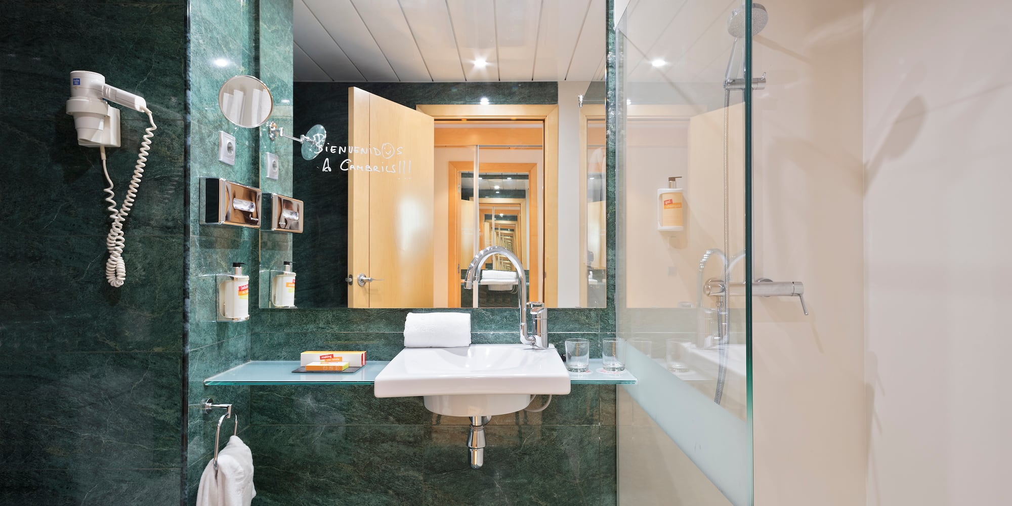 a bathroom with a glass shower and sink