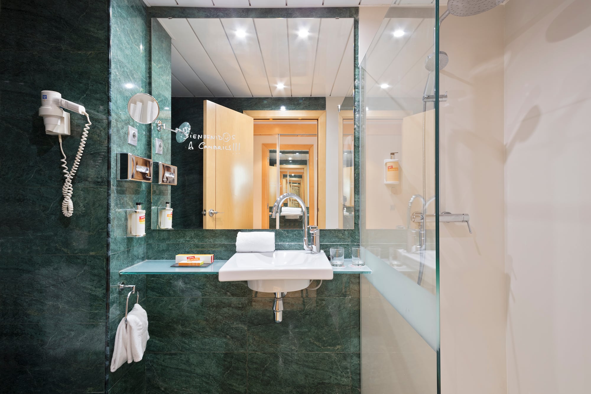 a bathroom with a glass shower and sink