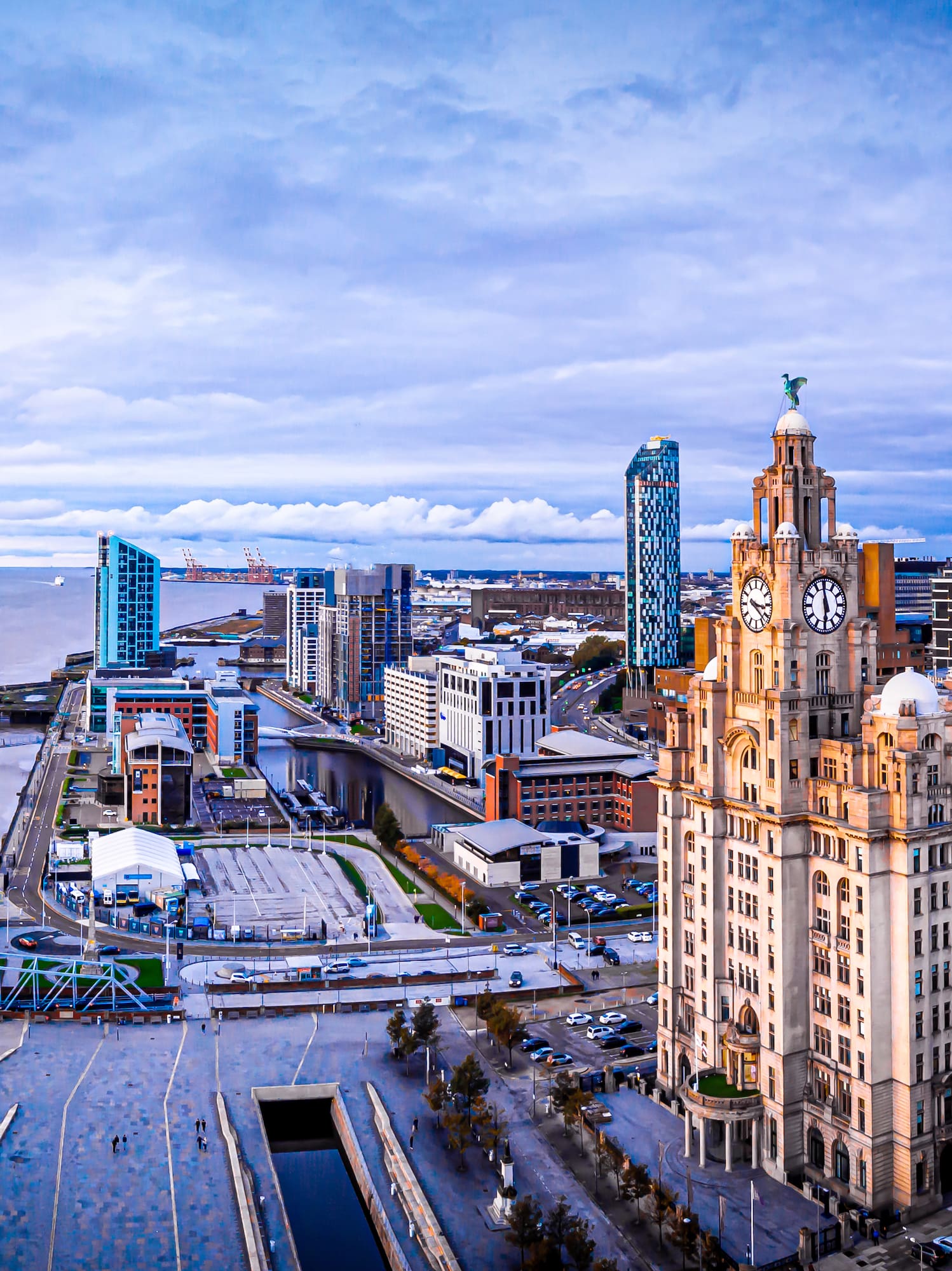 a city with a large building and a body of water