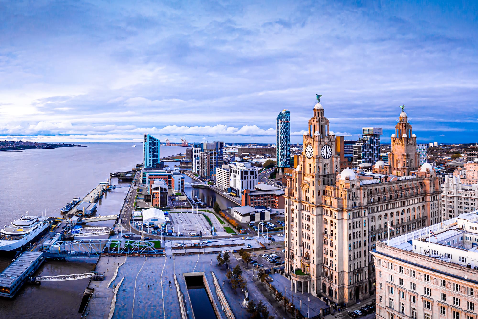 a city with a large building and a body of water