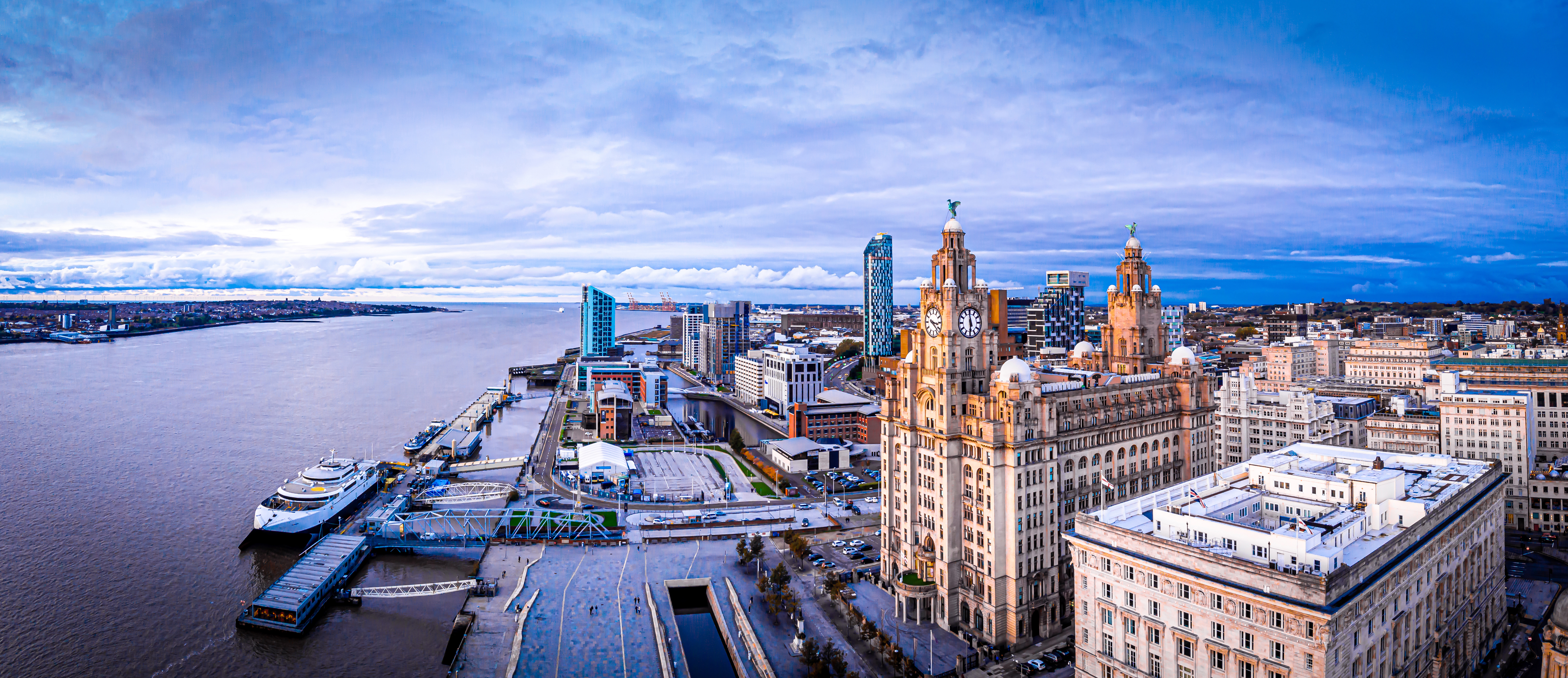 a city with a large building and a body of water