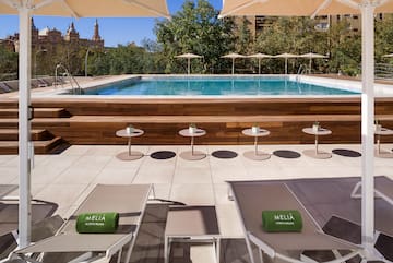 a pool with chairs and tables