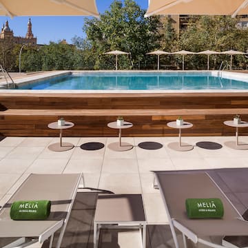 a pool with chairs and tables