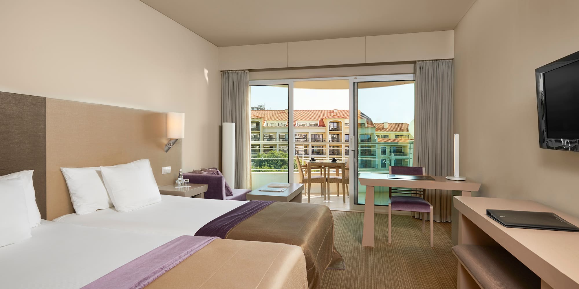 a room with two beds and a table