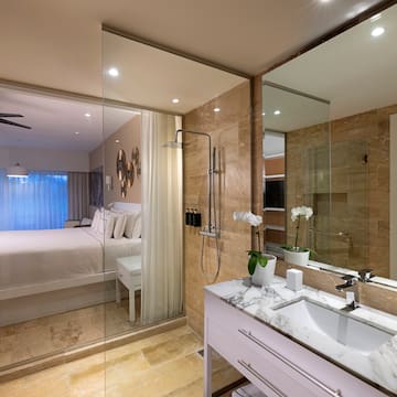 a bathroom with a bed and shower