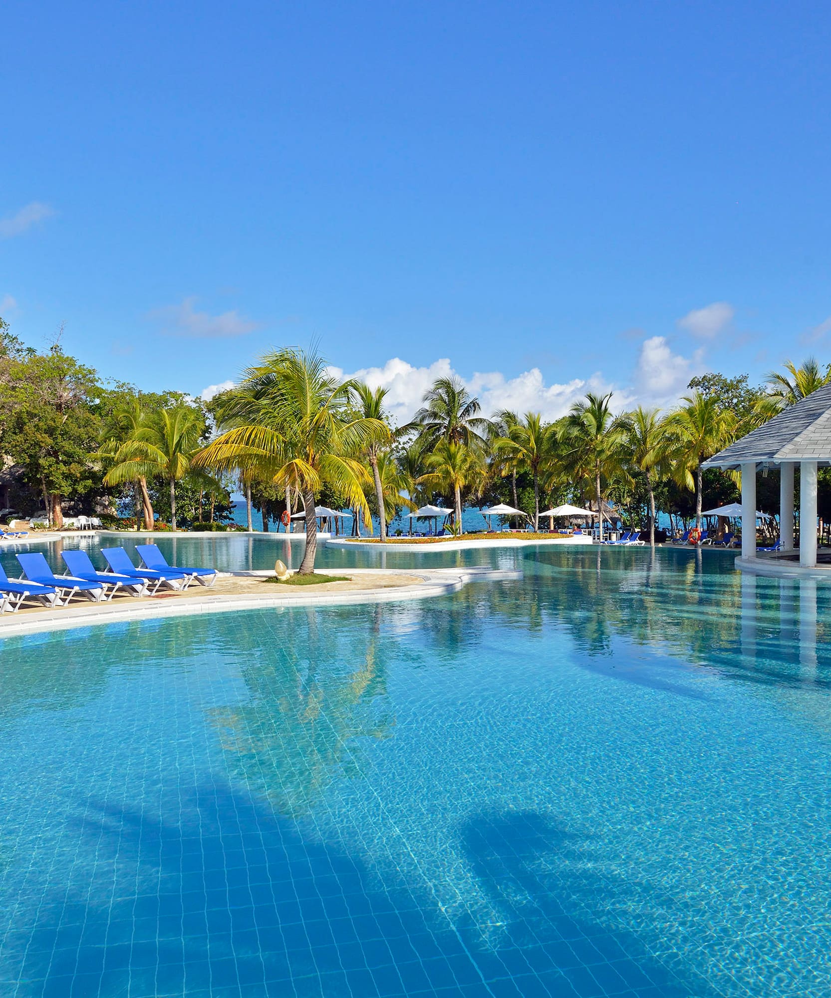 a pool with chairs and a gazebo