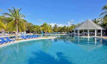 a pool with chairs and a gazebo