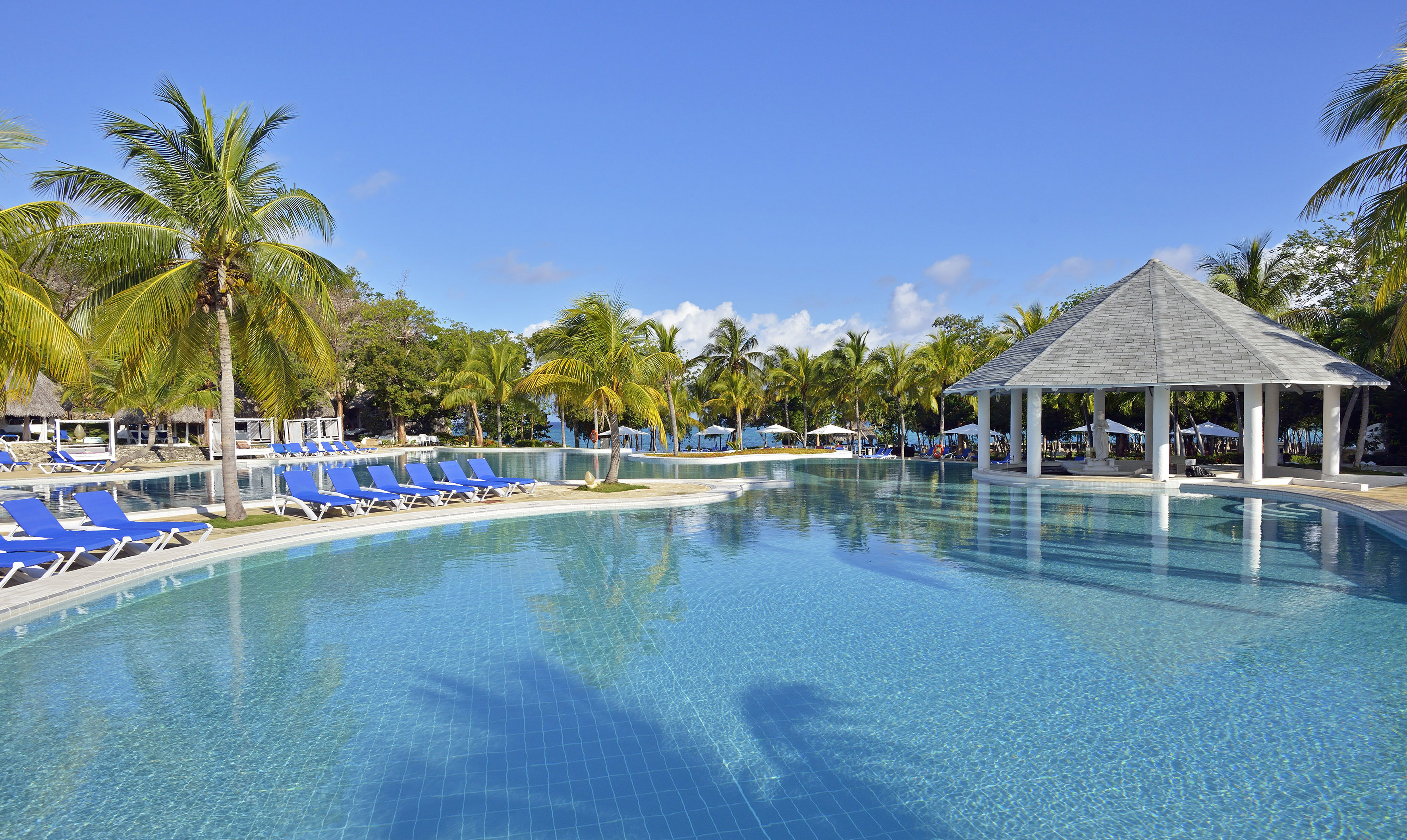 a pool with chairs and a gazebo