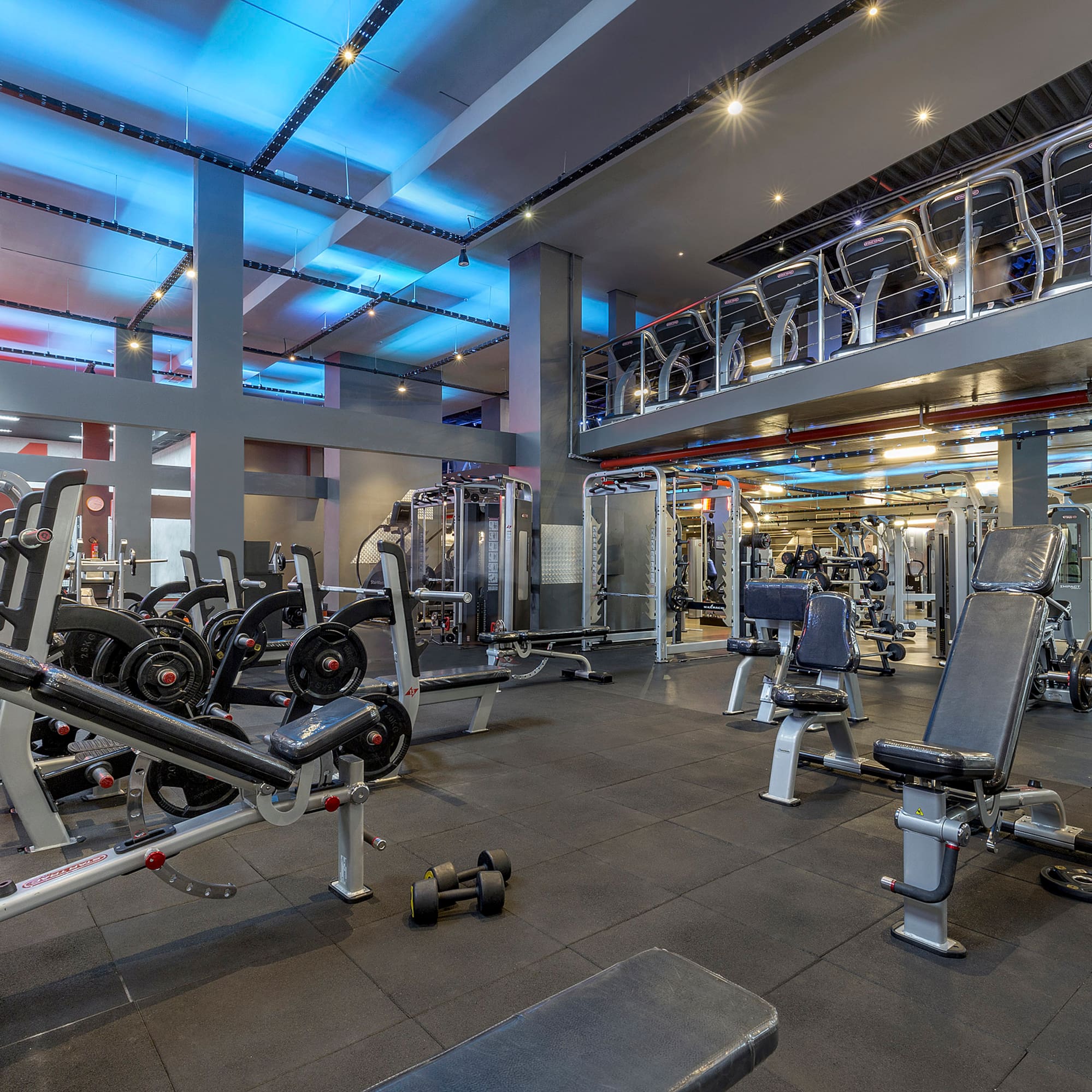 a gym with several exercise equipment