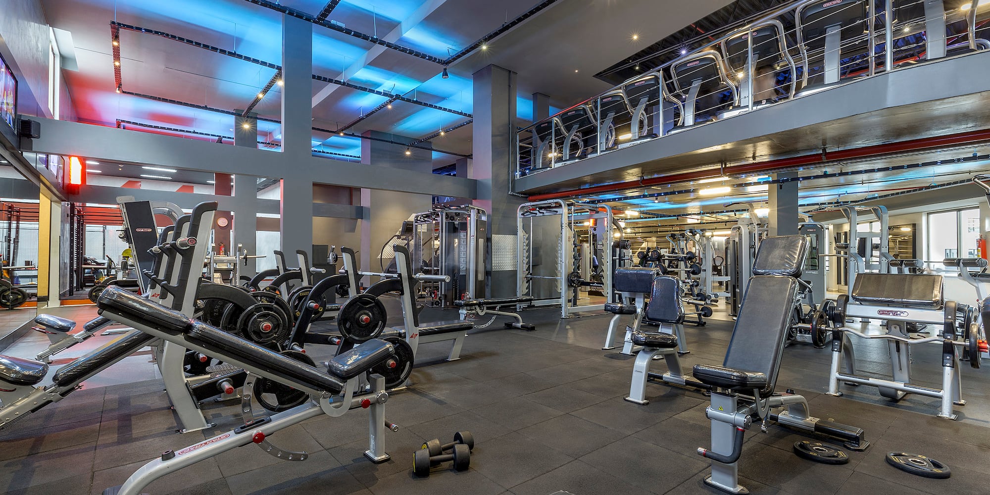 a gym with several exercise equipment