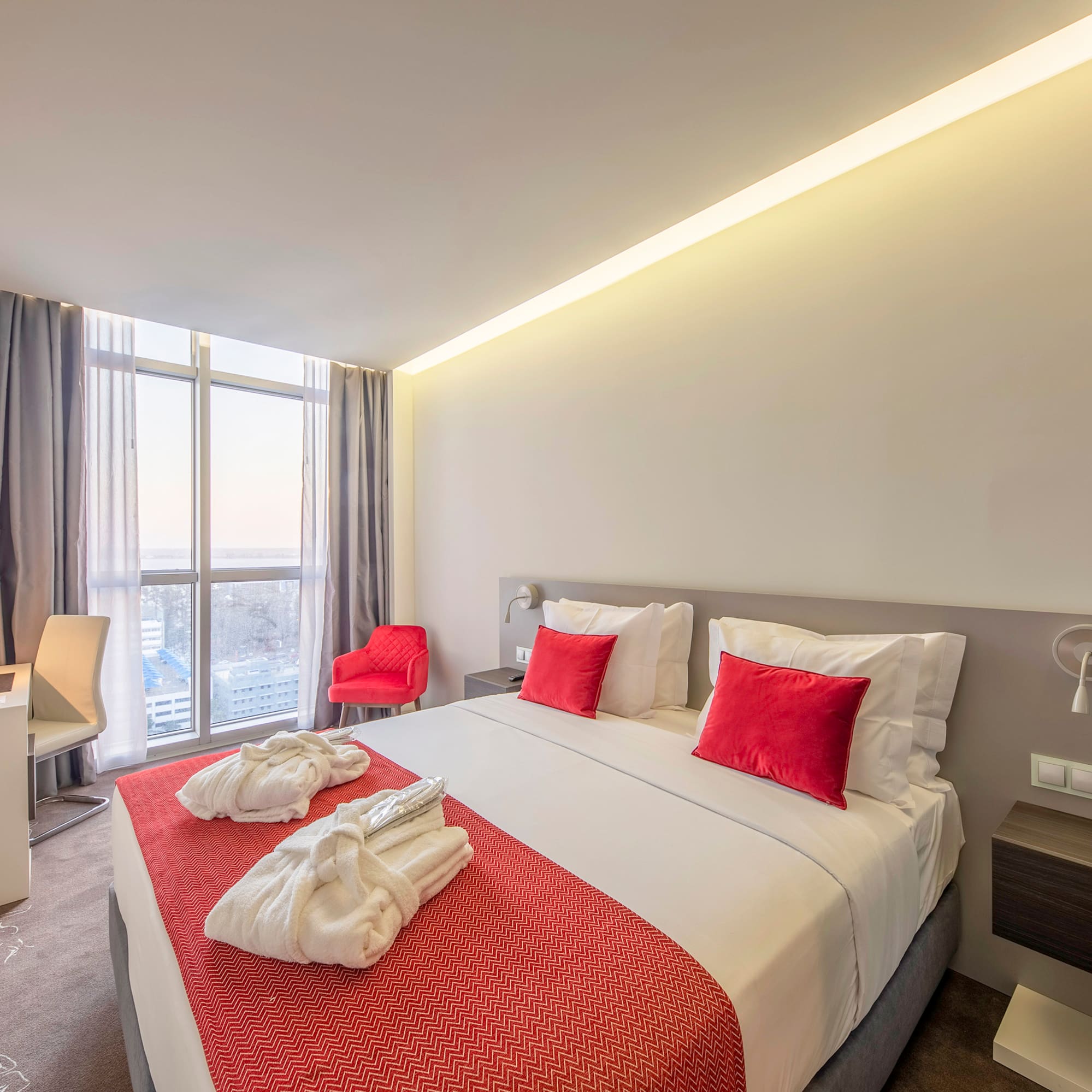 a bed with red and white towels on it