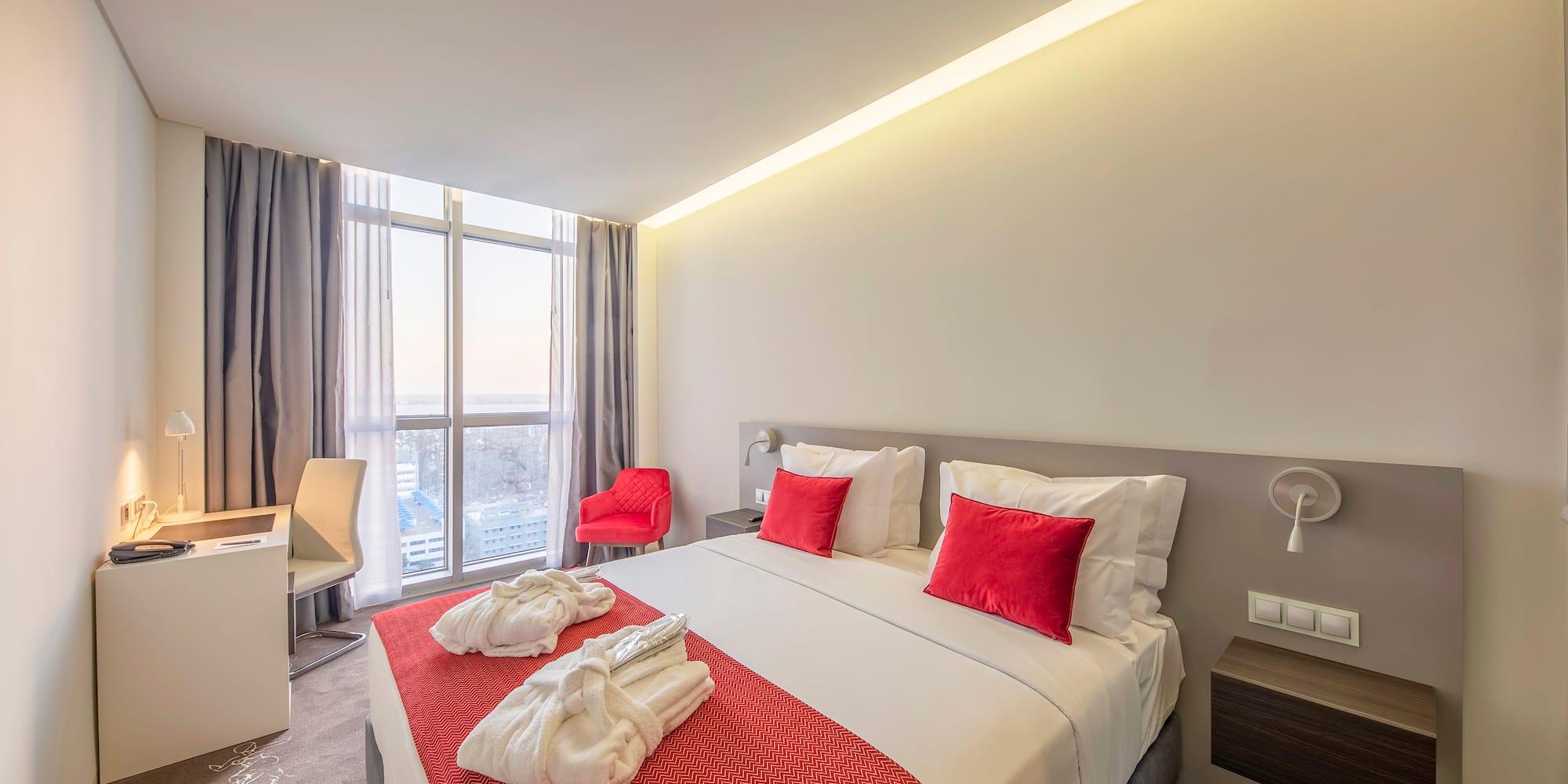 a bed with red and white towels on it