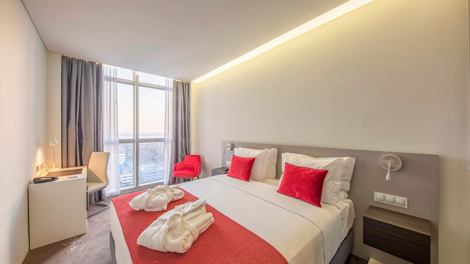 a bed with red and white towels on it