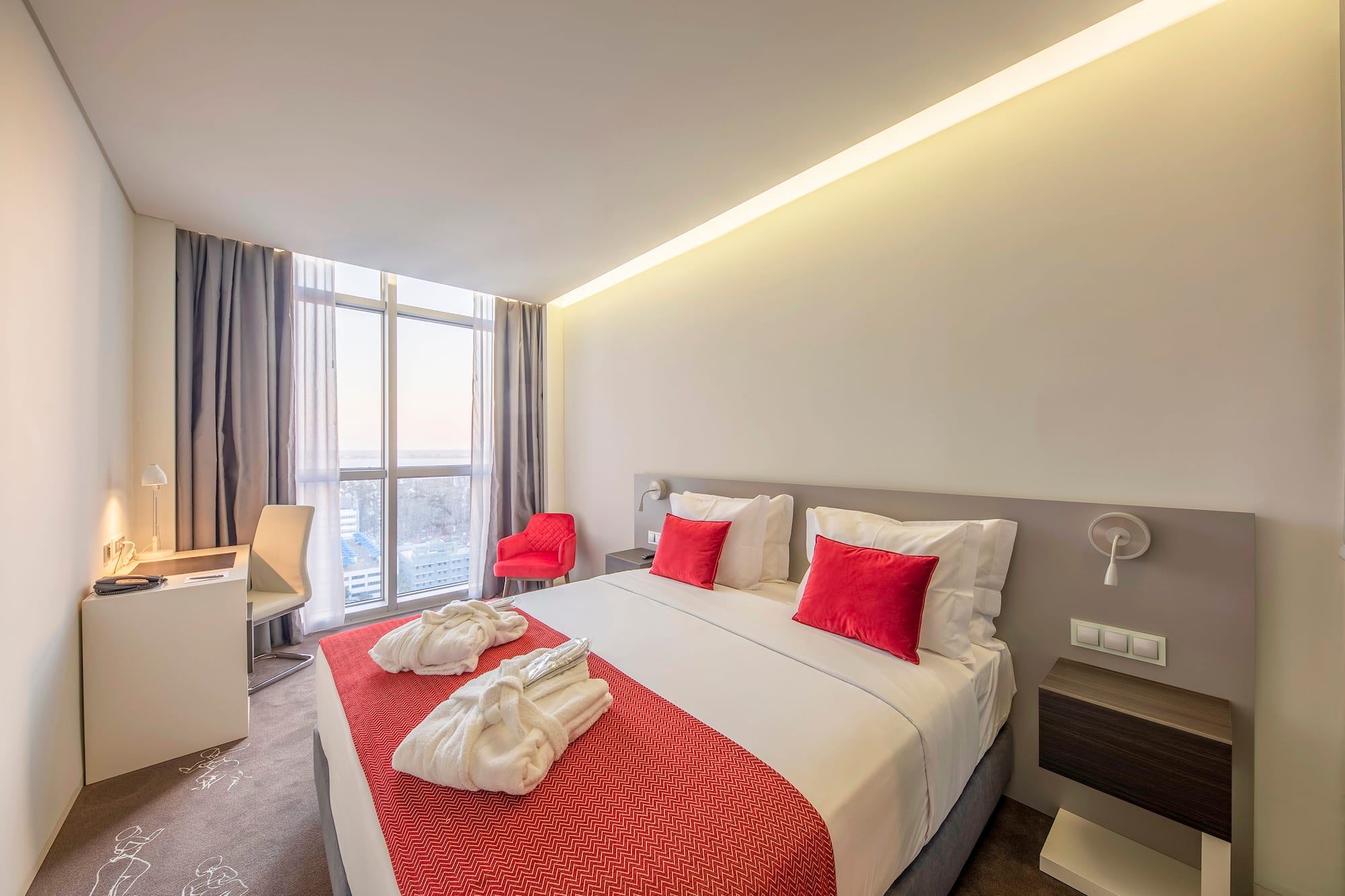 a bed with red and white towels on it