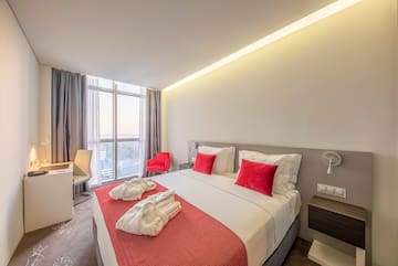 a bed with red and white towels on it