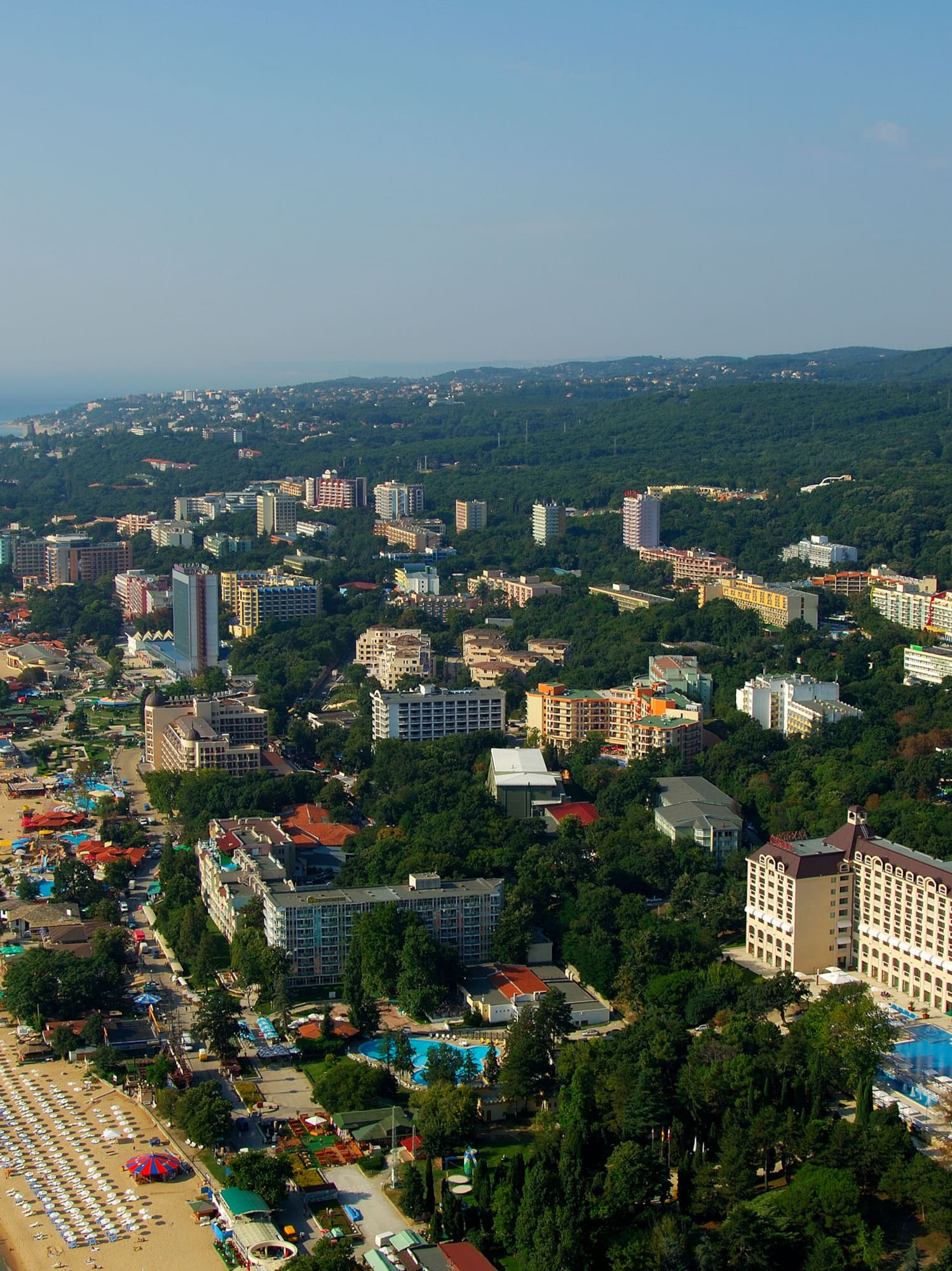 a aerial view of a beach with buildings and trees
