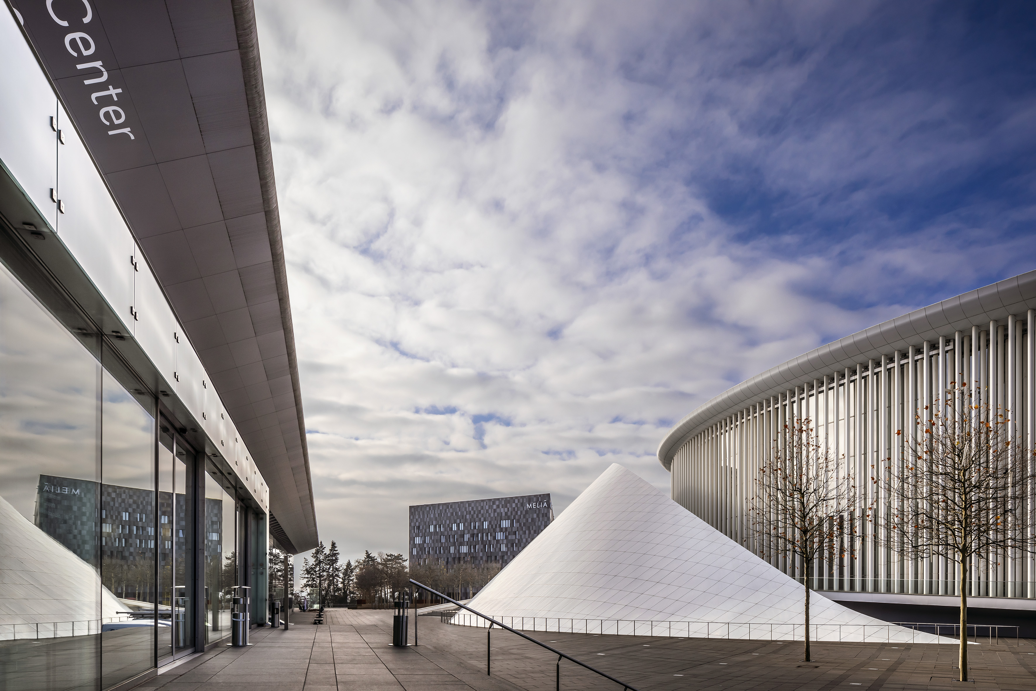 Philharmonie Luxembourg with white cone, Melia hotel, and modern plaza.