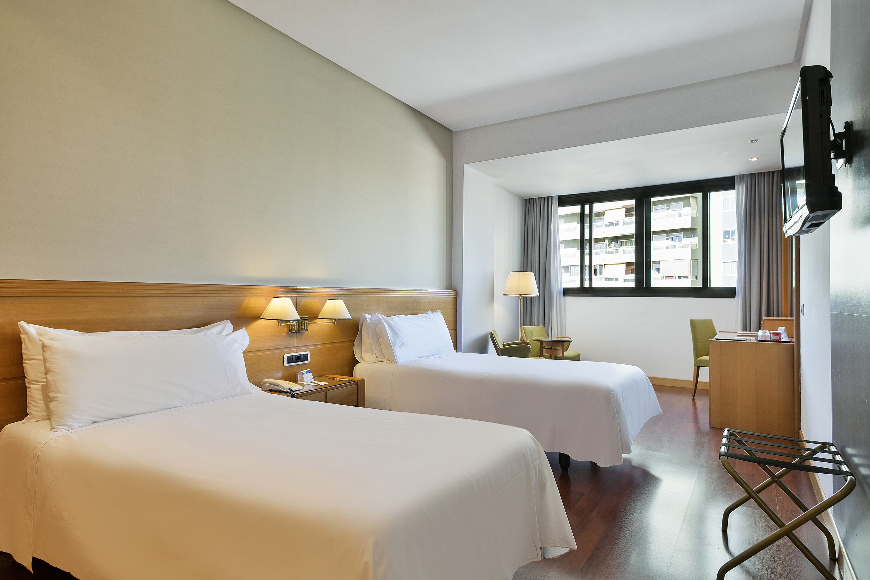 a room with two beds and a piano
